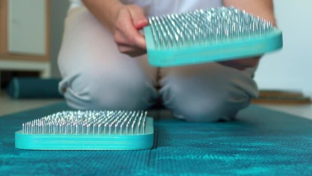 Open and put sadhu board for sadhu yoga practice. Get up on nails. Board with needles, side view. The concept of a healthy practice of sadhu yoga.