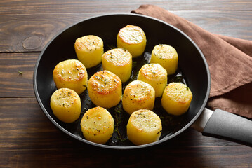 Fondant potatoes in frying pan