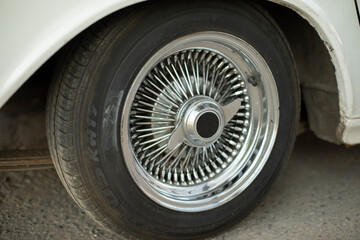 Old disc of car. Wheel is retro car. Details of rare transport.