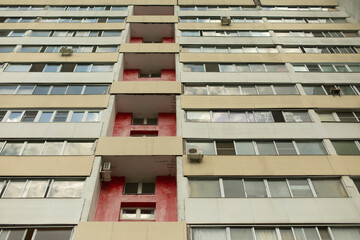 Residential building with red wall. Windows in house.