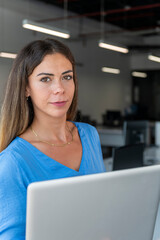 Businesswoman on laptop at office - stock photo