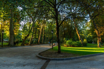Urban park with some person and sunset sunlight in summer, Campo de San Francisco, Oviedo, Asturias, Spain