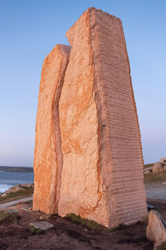Granite monument (A ferida) with a central crack facing the sea, in memory of the ecological disaster of the sunken oil tanker in 2002, Muxia, Galicia