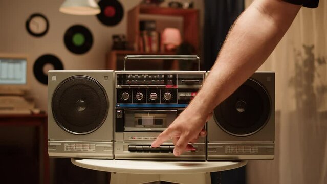 Retro radio tape recorder close-up. Listening to music, old radio boombox player at home, searching channel or wave. 