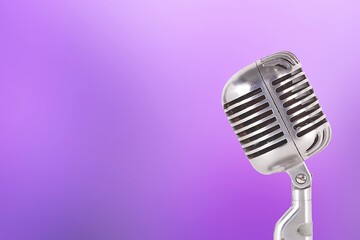 Fototapeta na wymiar Retro vintage microphone on abstract purple background