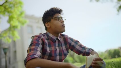 African American student having lunch during break time, resting after classes