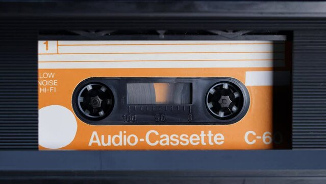 Retro radio tape recorder, audio cassette close-up. Listening to music, old radio boombox player, searching channel. 