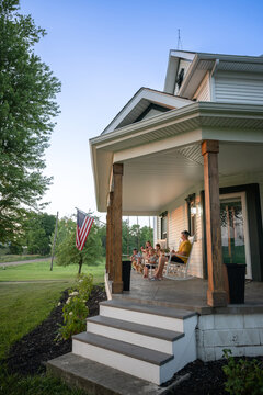 Marine veteran at home with family during sunset on front porch.