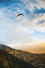 Paragliding during Sunset by Mountain