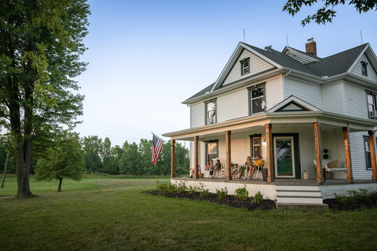 Marine veteran at home with family during sunset on front porch.