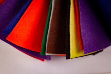 Several colored felt texture background. Assorted color felt fabric sheets, patchwork, sewing DIY craft