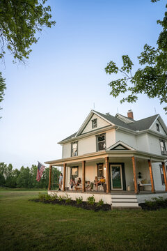 Marine veteran at home with family during sunset on front porch.