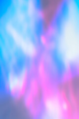 Blurred water texture overlay effect for photo and mockups. Organic drop diagonal shadow and light caustic effect on holographic pink blue wall. Shadows for natural light effects