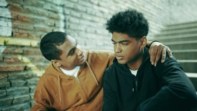 Teenage guy comforting his disappointed friend, brotherly love, friendship