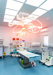 Medical emergency devices in modern operating room. Surgery hospital room.