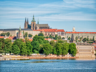 Beautiful view with the Prague Castle and old traditional houses with red roof tiles.