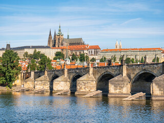 Fototapeta na wymiar View with the Charles Bridge main touristic attraction with the Prague Castle in the background