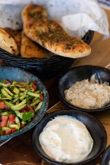 Israel and Lebanon cuisine served in restaurant. Middle eastern or Arabic Oriental restaurant. Several appetizer dishes and spreads for bread  and salad. 