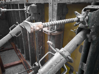 Cast-in-place concrete works. Scaffolding structures. Metal props hold formwork at construction site. 