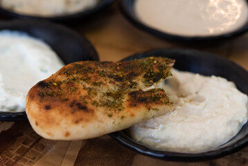 Israel and Lebanon cuisine served in restaurant. Middle eastern or Arabic Oriental restaurant. Several appetizer dishes and spreads for bread  and salad. 