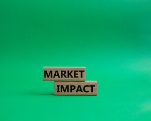 Market impact. Concept word Market impact on wooden cubes. Beautiful green background. Business and Market impact concept. Copy space.