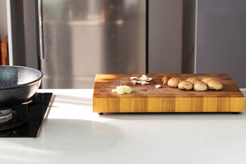Close up of Chef cook hands chopping champignons. Professional chef cook cutting mushrooms for Italian cuisine