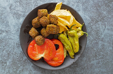 Vegetable patties for vegan burgers in plate, gray marble background.