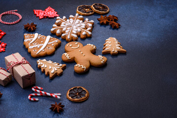 Elements of Christmas decorations, sweets and gingerbread on a wooden cutting board