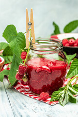 homemade raspberry jam or confiture on light background. vertical image. top view. place for text