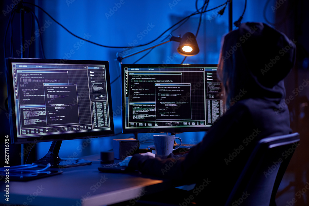 Poster cybercrime, hacking and technology concept - female hacker in dark room writing code or using comput