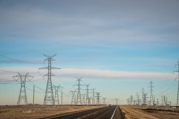 High voltage power lines along road.