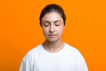 Portrait of young adult indian woman in T-shirt