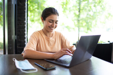 Indian business woman working on her laptop outdoor