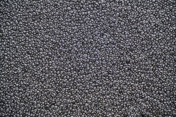 Abstract background, grey foam texture, porous material made up cells that do not communicate with each other.