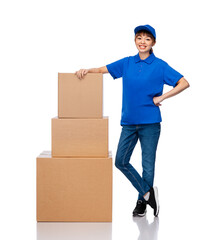 mail service and shipment concept - happy smiling delivery woman with parcel boxes in blue uniform over white background
