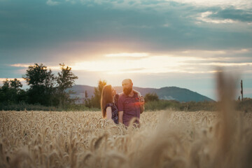 Fototapeta na wymiar Loving couple in a wheat field.
