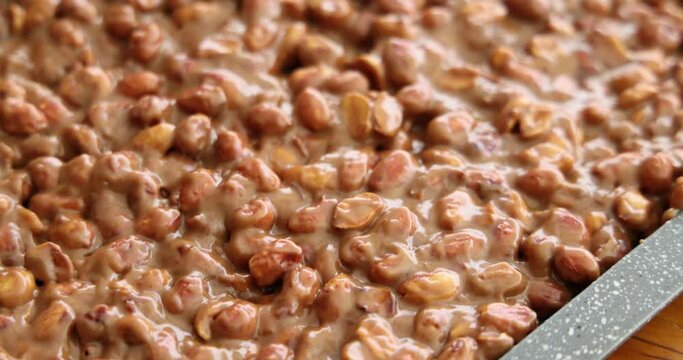 artisanal production of very traditional sweets in the region of Minas Gerais and Goiania made with peanuts, sugar and butter forming a plate that is then cut into cubes