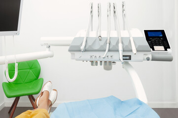 Patient waiting to be seen by the dentist, dental unit and tools ready to work.