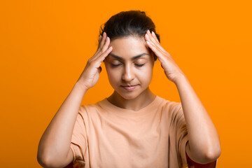 Close up portrait of young indian american woman doing facebuilding yoga face gymnastics yoga self massage