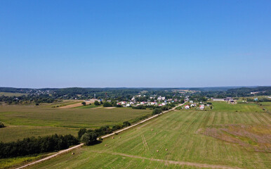 Fototapeta na wymiar Aerial view of agro fields with harvesting and haystacks