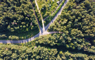 Aerial view of a suburban road. Landscape forest and fields