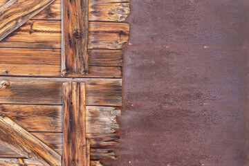 Heavily textured dual two sided weathered background with tattered reclaimed primitive wooden planks and rusted metal