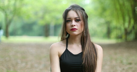 Unhappy young woman in 20s pointing finger to camera shaking head in disagreement