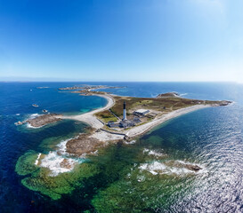 Great lighthouse of the Island of Sein in Brittany, France, in the Atlantic Ocean - Small flat isolated island with a black and white, tall and round lighthouse © Alexandre ROSA