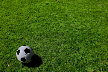 A traditional soccer ball lies on the pitch prior to a game