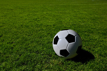 A traditional soccer ball lies on the pitch prior to a game