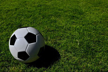 A traditional soccer ball lies on the pitch prior to a game