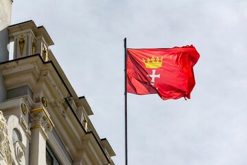 Gdansk city flag on flagpole waving in wind