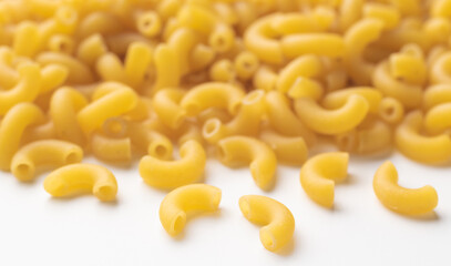 Uncooked macaroni with selective focus on front noodle
