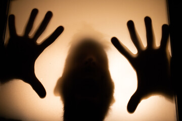 scary picture of hands behind glass, horror ghost woman behind door, Halloween  concept